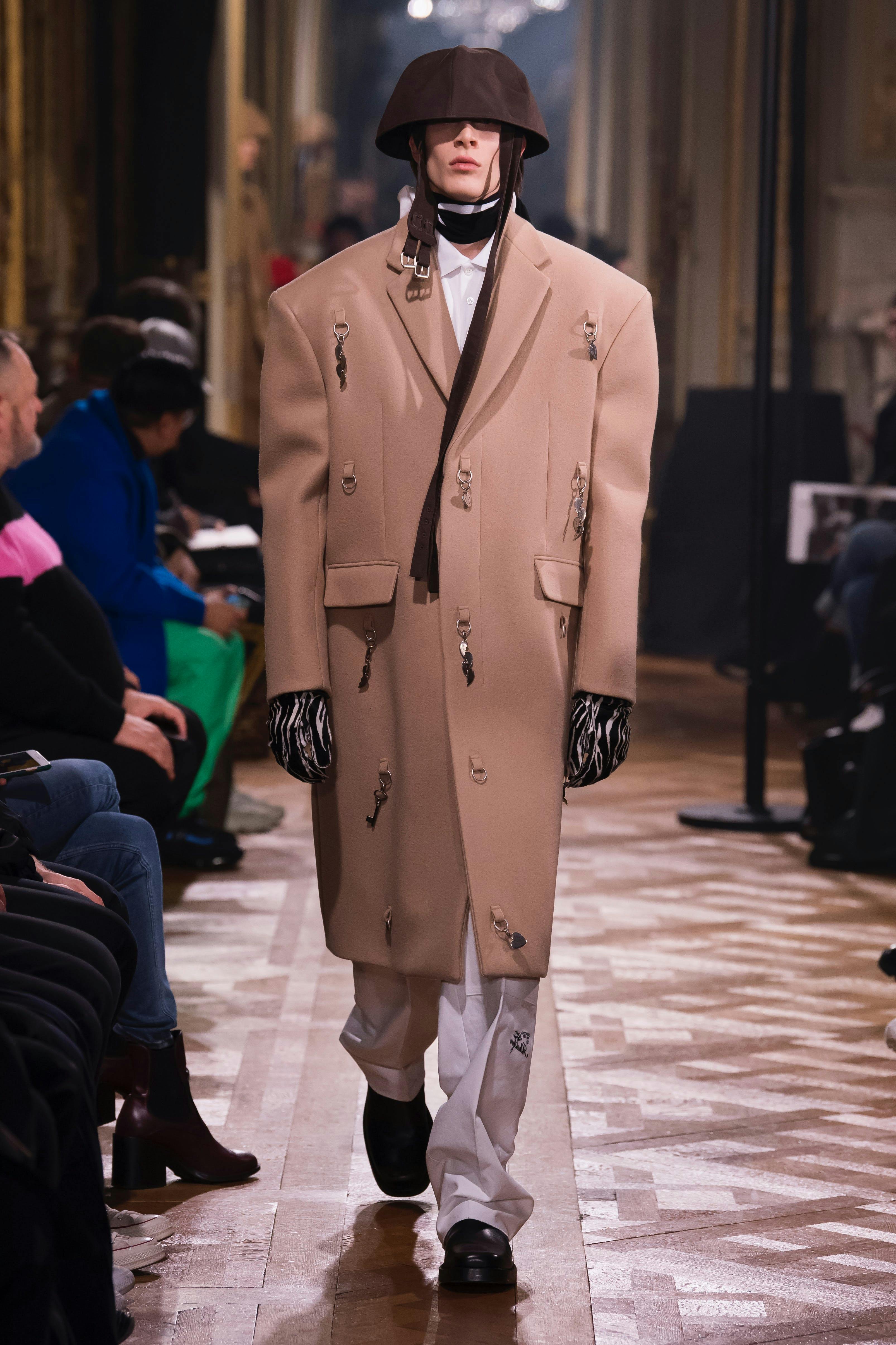 clothing apparel person human overcoat coat helmet suit
