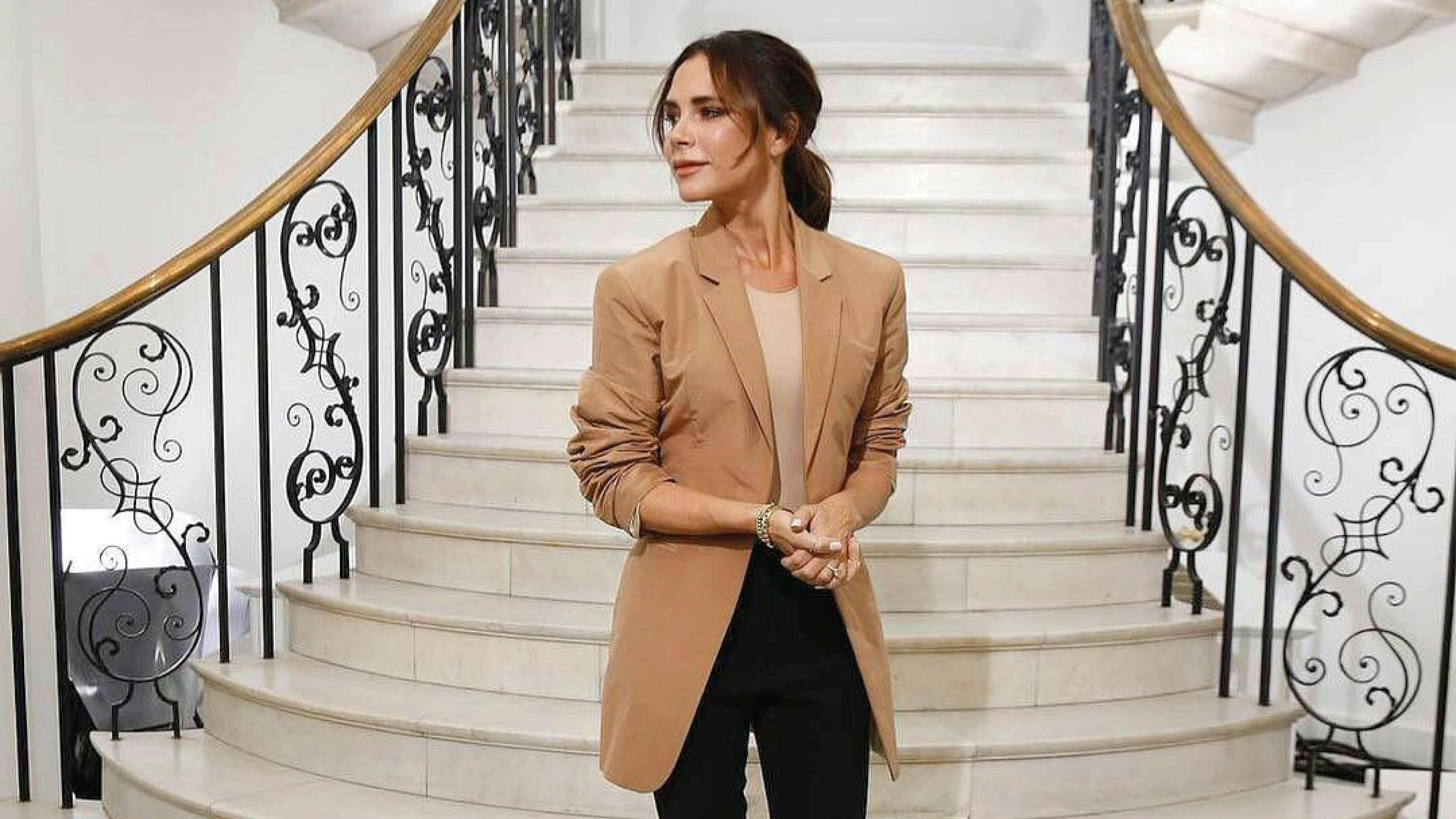 clothing apparel person overcoat coat blazer jacket staircase handrail female