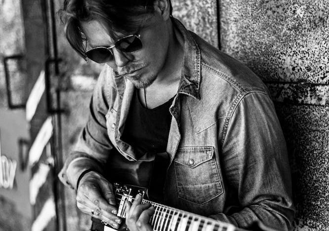 musician musical instrument person human sunglasses accessories guitar leisure activities guitarist performer