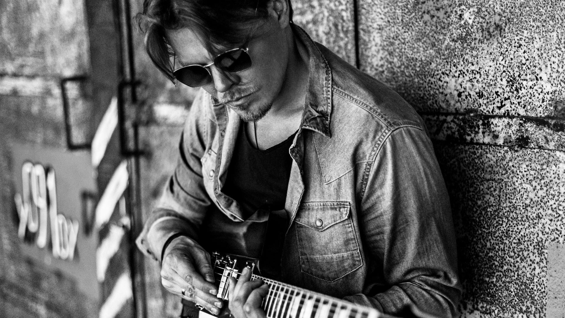 musician person musical instrument human sunglasses accessories guitarist performer guitar leisure activities