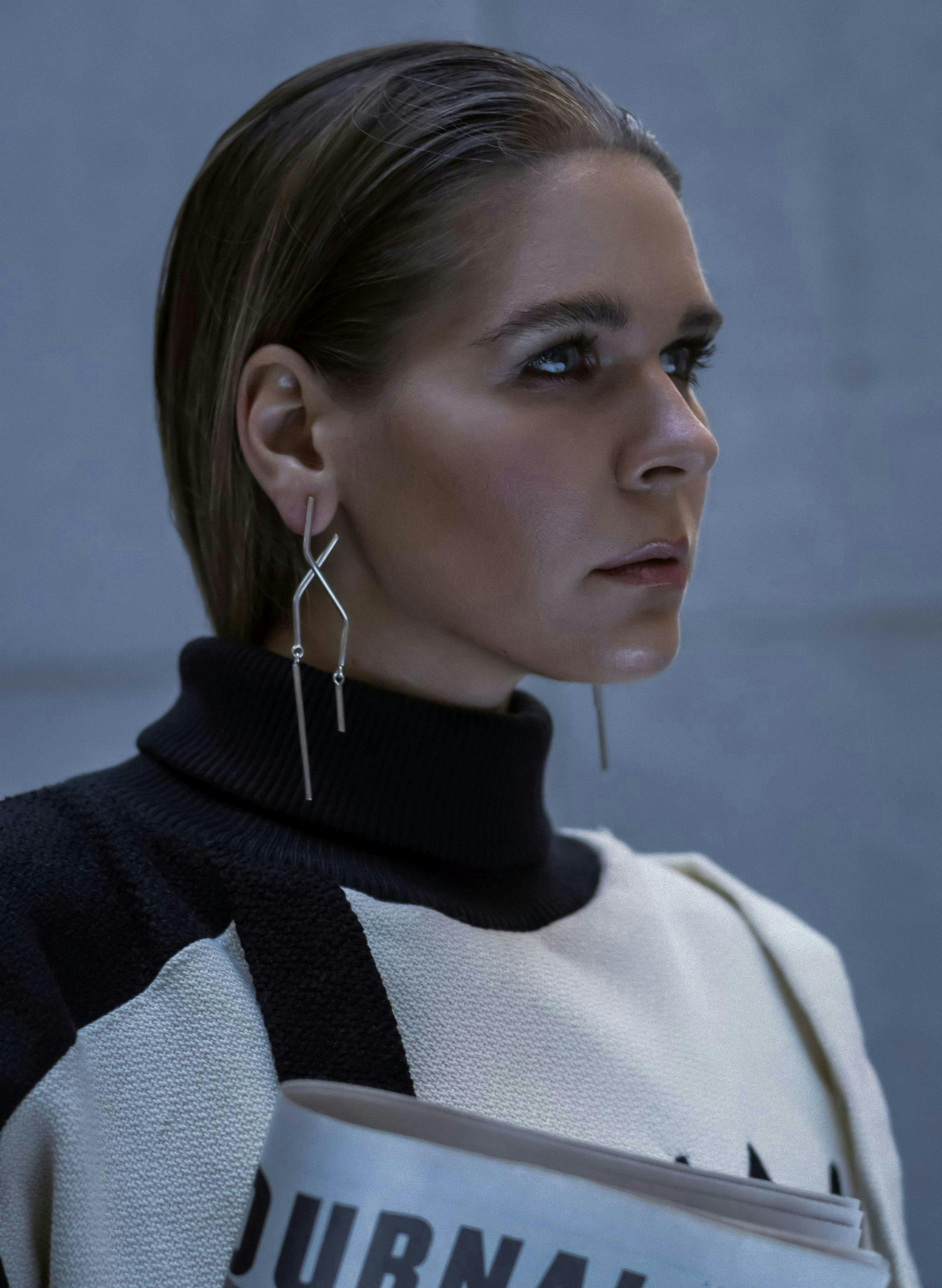 earring accessories sweater knitwear person woman adult female portrait long sleeve