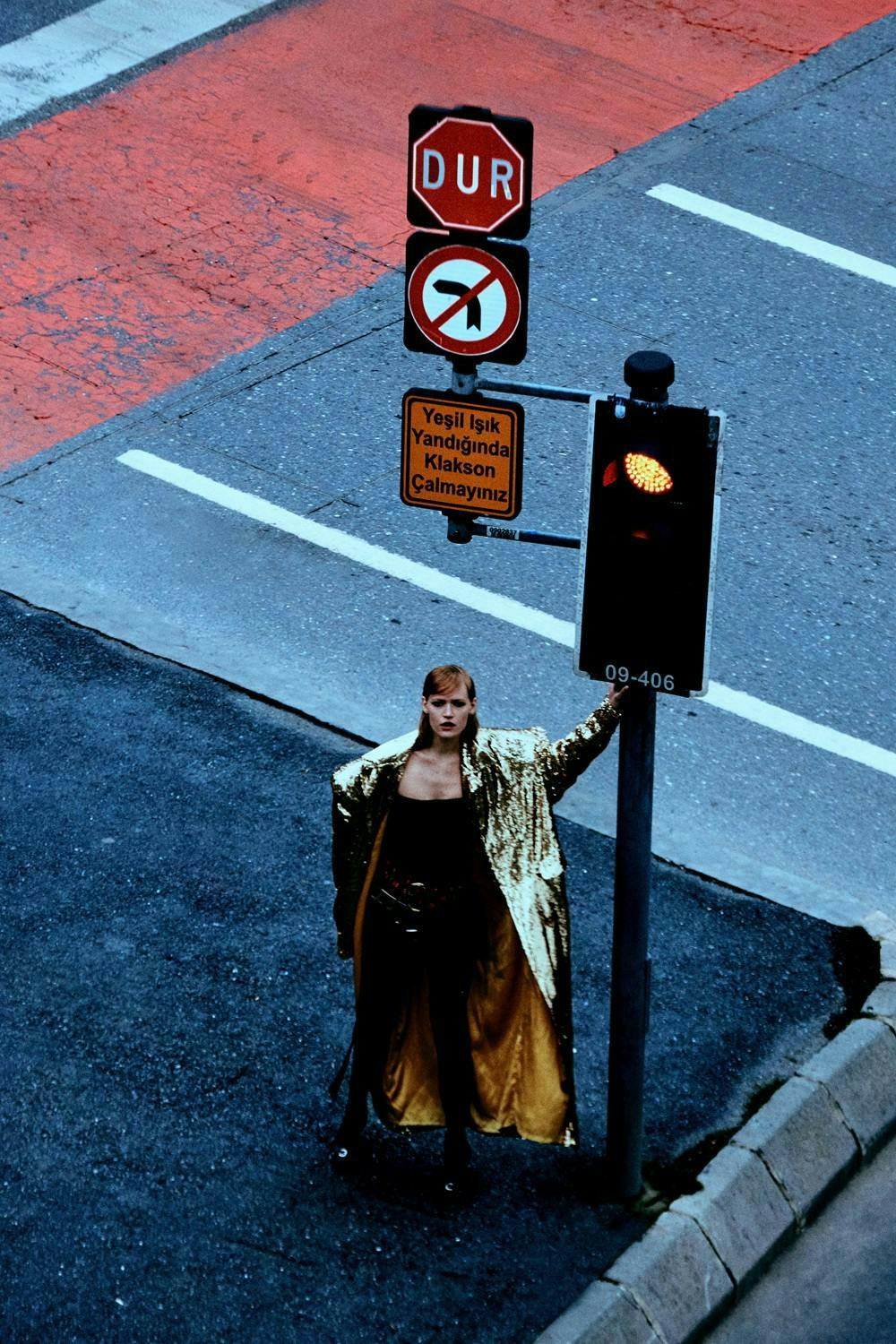 coat light road tarmac adult female person woman traffic light fashion
