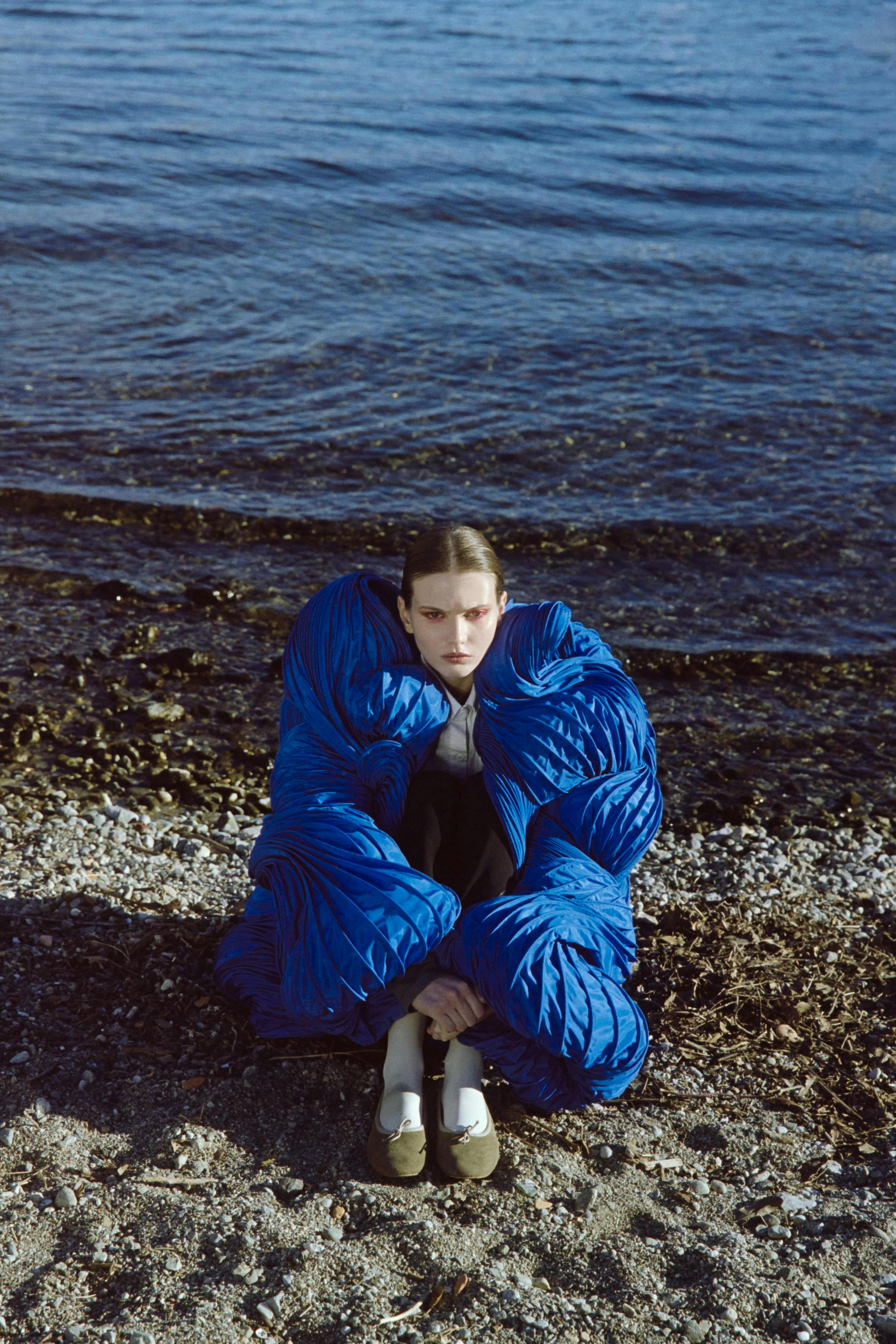 coat jacket face person photography portrait blanket outdoors sea shoe
